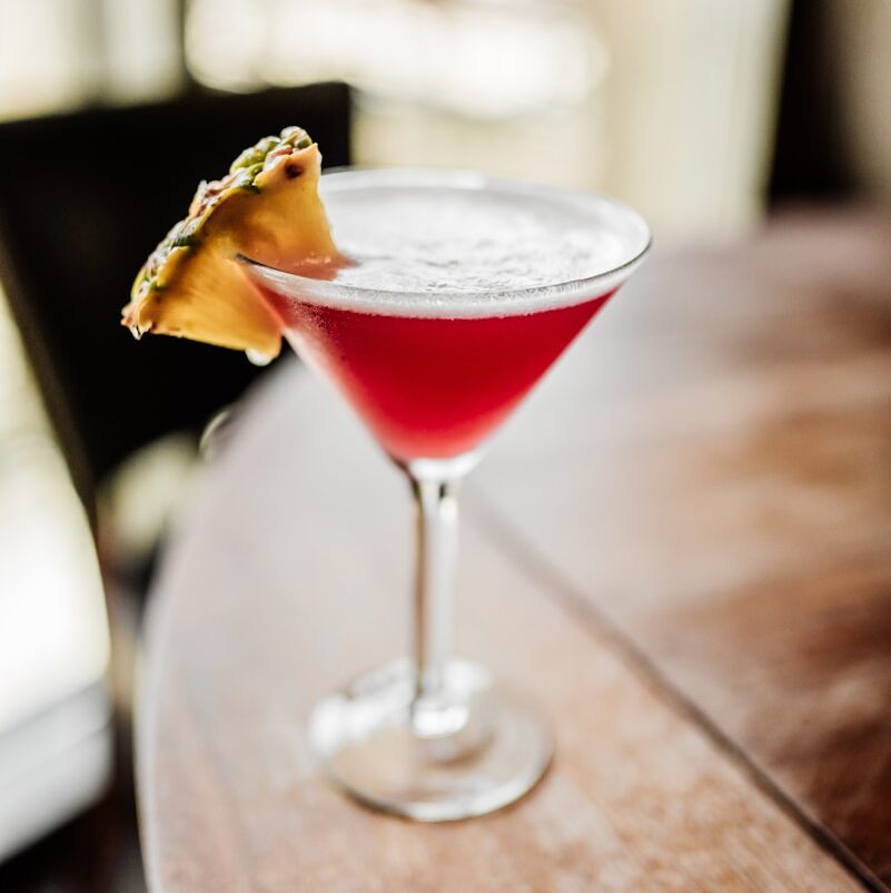 clear martini glass with red liquid